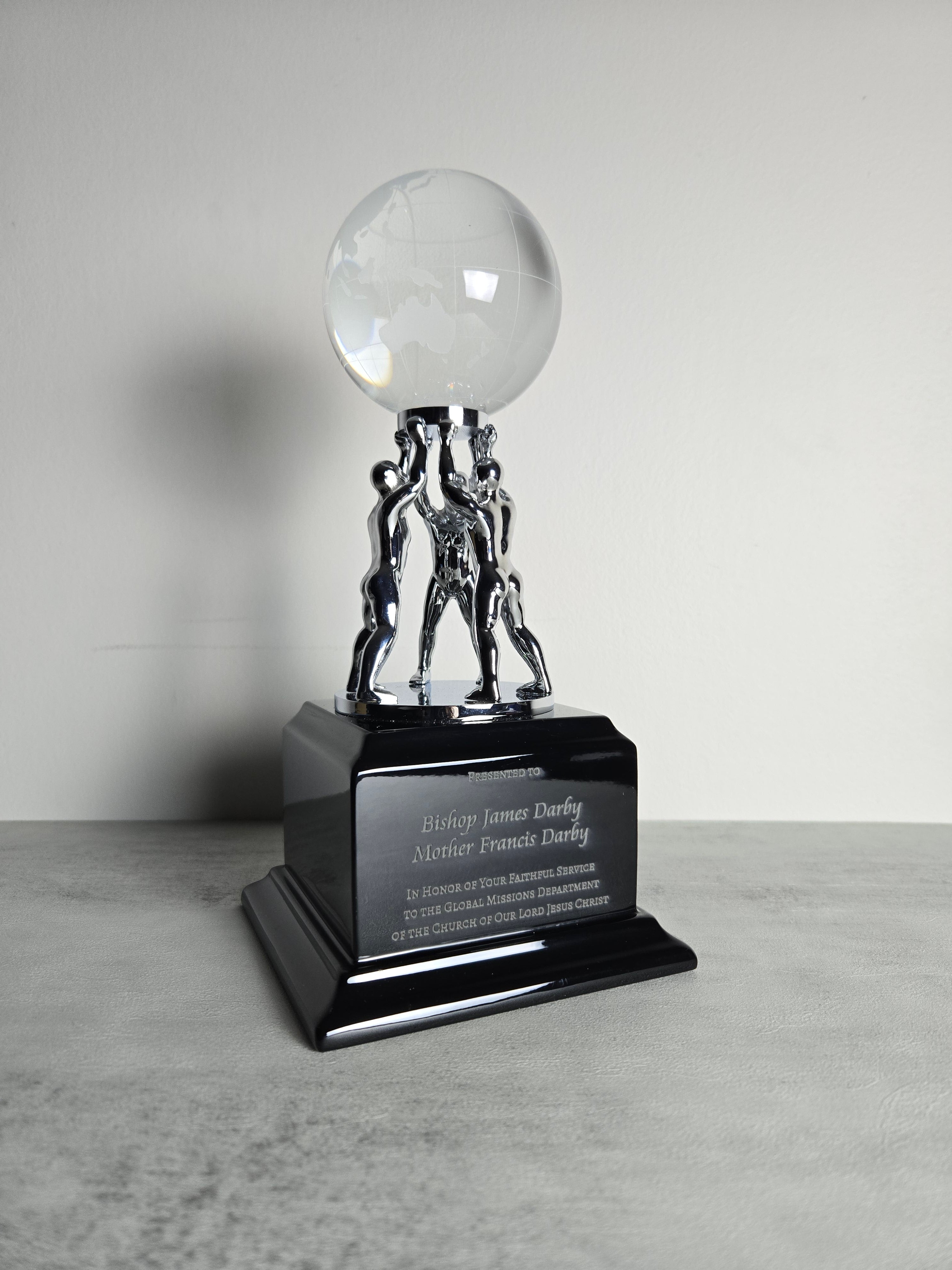 Clear Crystal Globe with Silver Men/Stand on Black Piano Finish Base